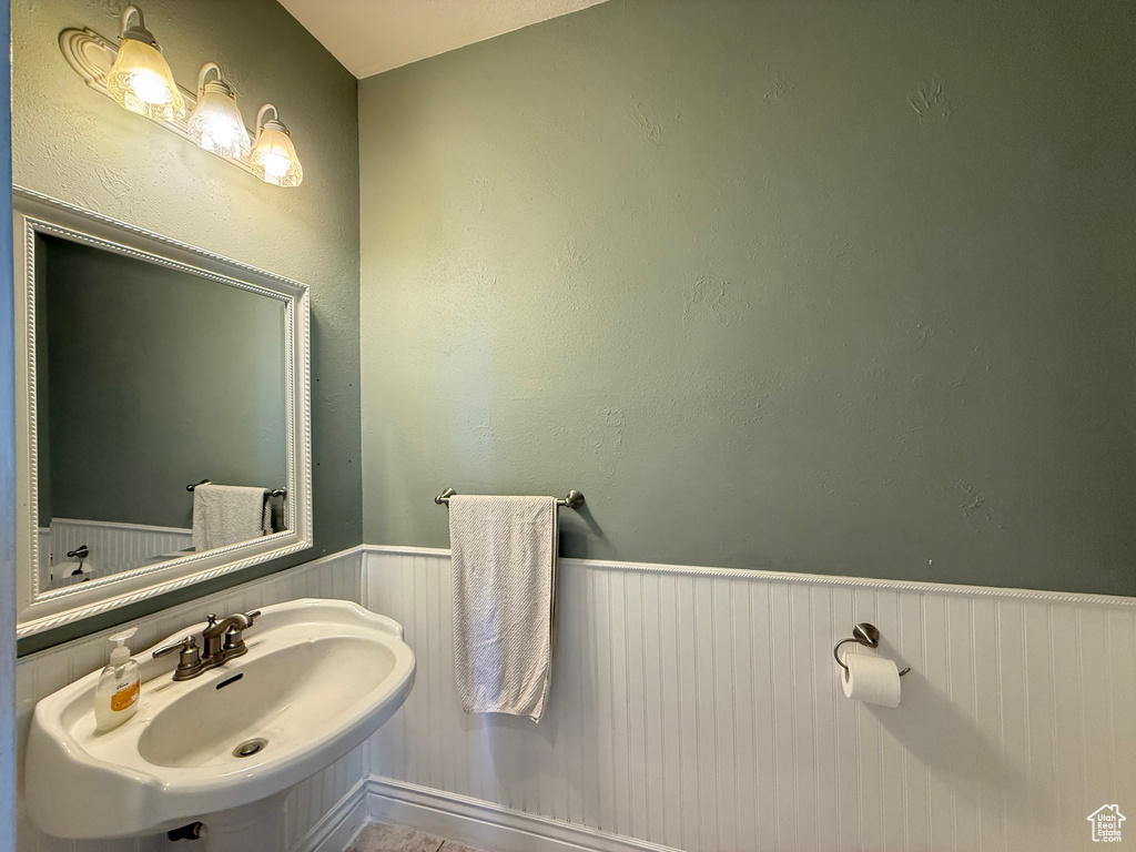 Bathroom with wainscoting and a sink