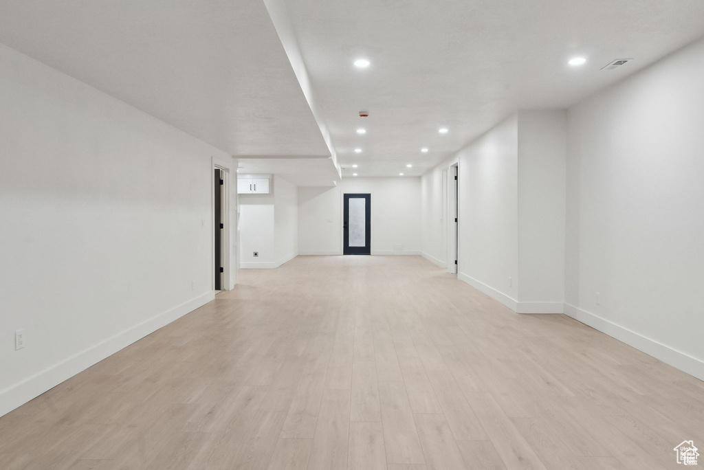 Spare room featuring recessed lighting, baseboards, and light wood-type flooring