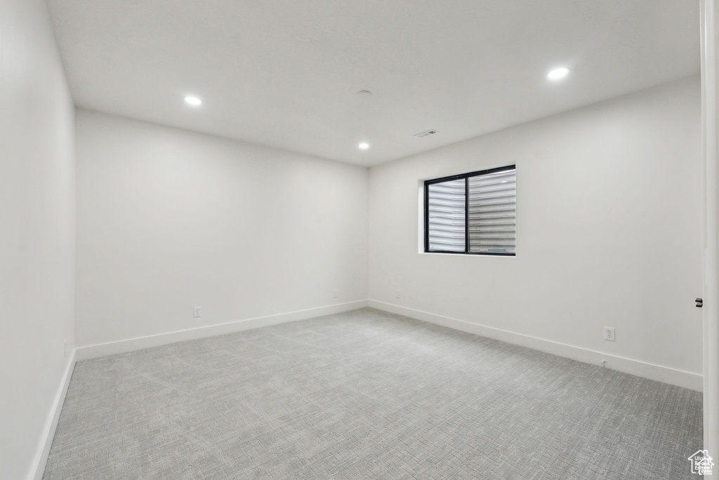 Empty room with recessed lighting, light carpet, and baseboards
