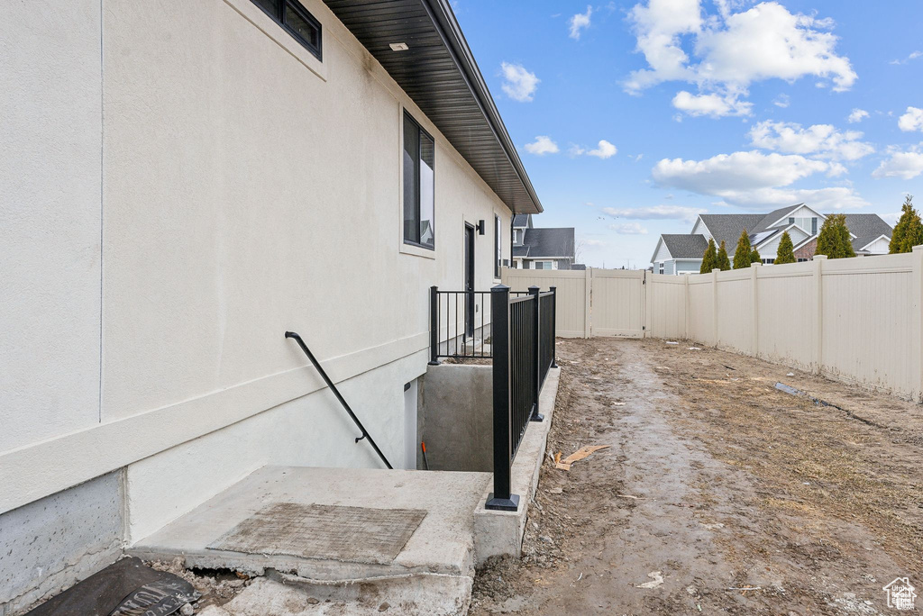 View of property exterior featuring a fenced backyard and stucco siding