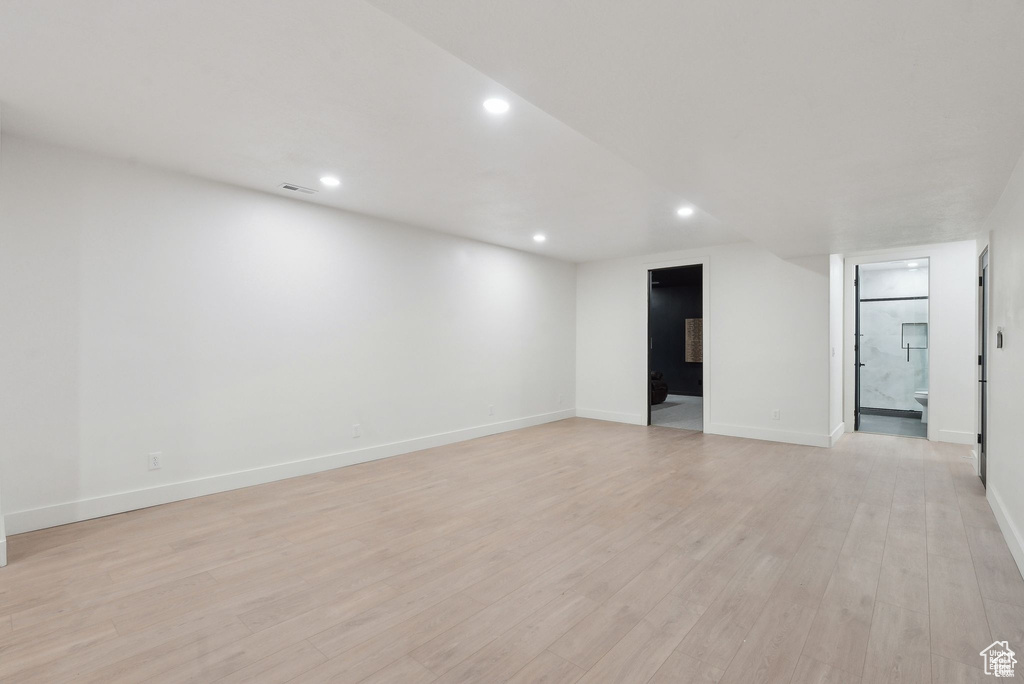 Unfurnished room with recessed lighting, light wood-style flooring, and baseboards