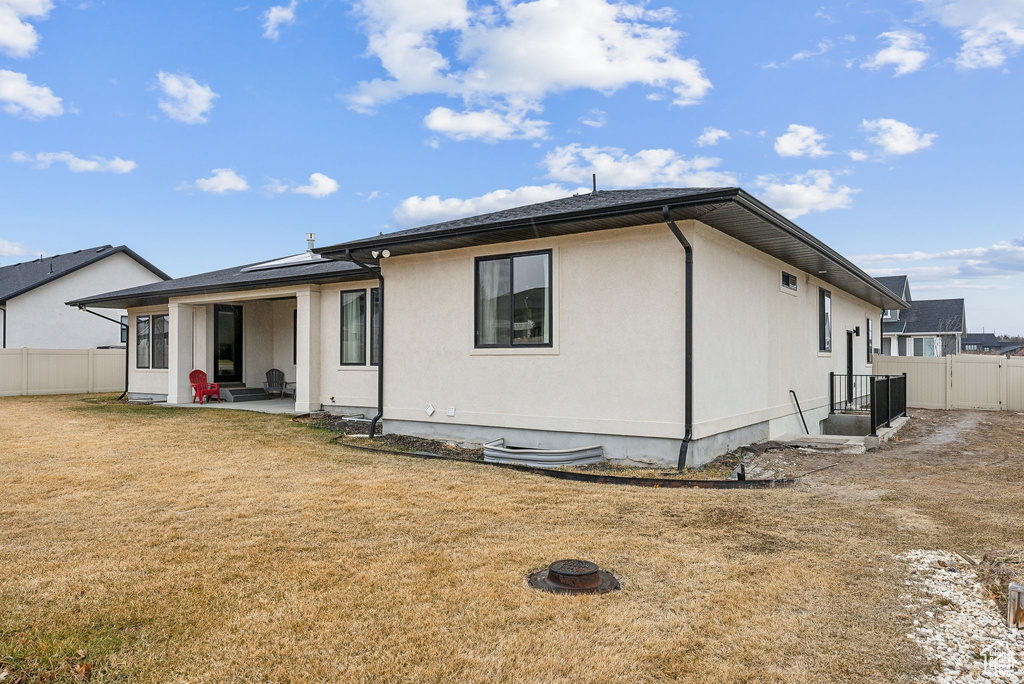 Back of property with a patio