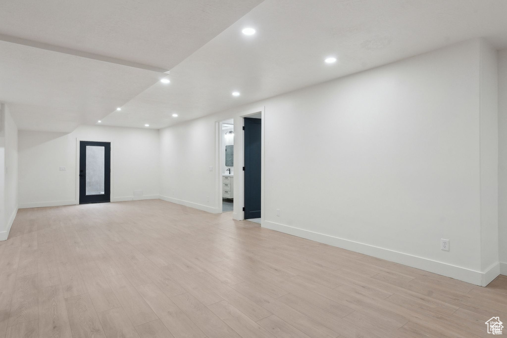 Unfurnished room with light wood finished floors, baseboards, and recessed lighting