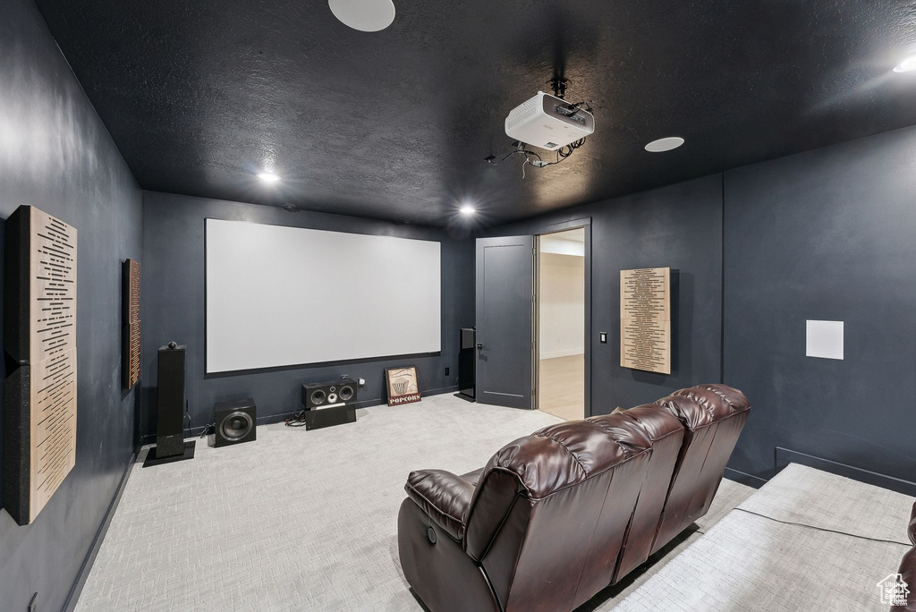 Cinema room with carpet flooring, a textured ceiling, and recessed lighting