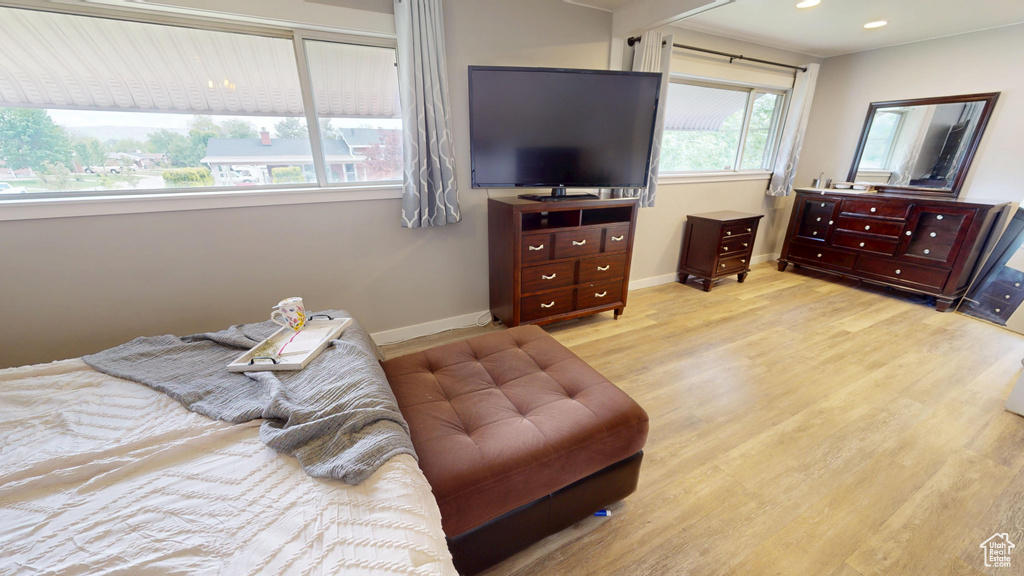 Bedroom with wood finished floors, baseboards, and recessed lighting