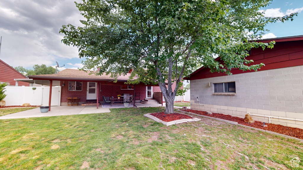View of yard with a patio area and entry steps
