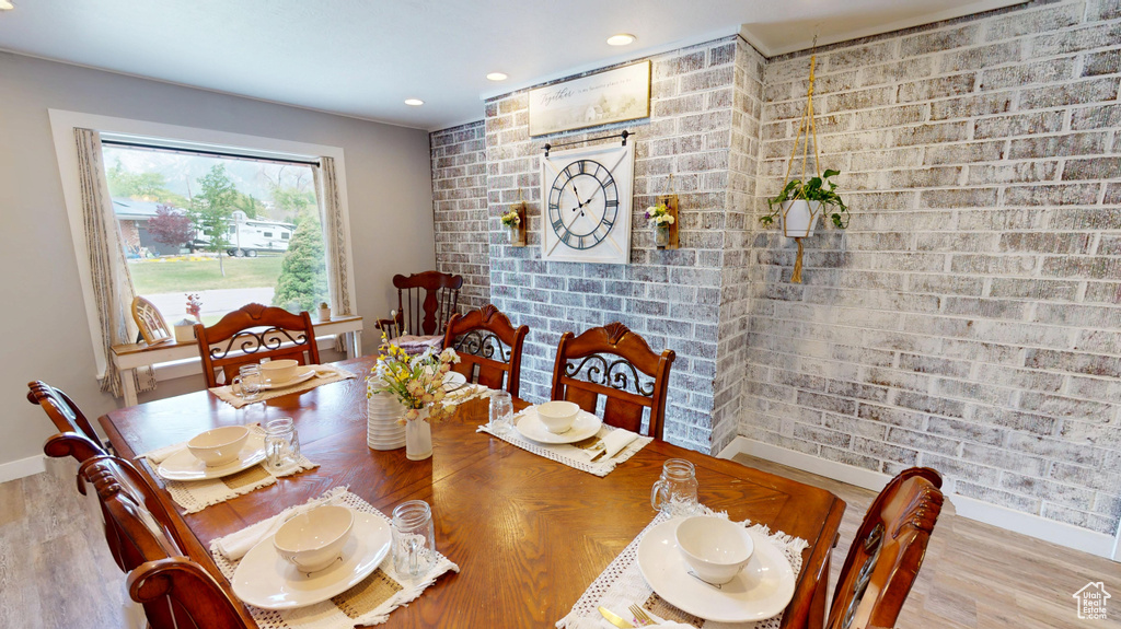 Dining area with baseboards, wood finished floors, and recessed lighting