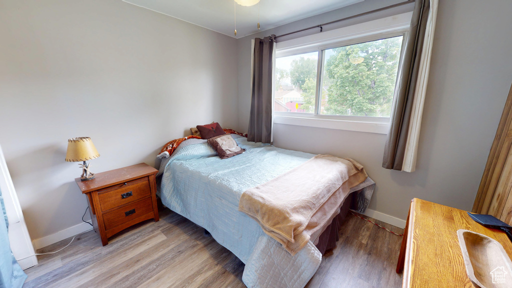 Bedroom featuring light wood-type flooring and baseboards