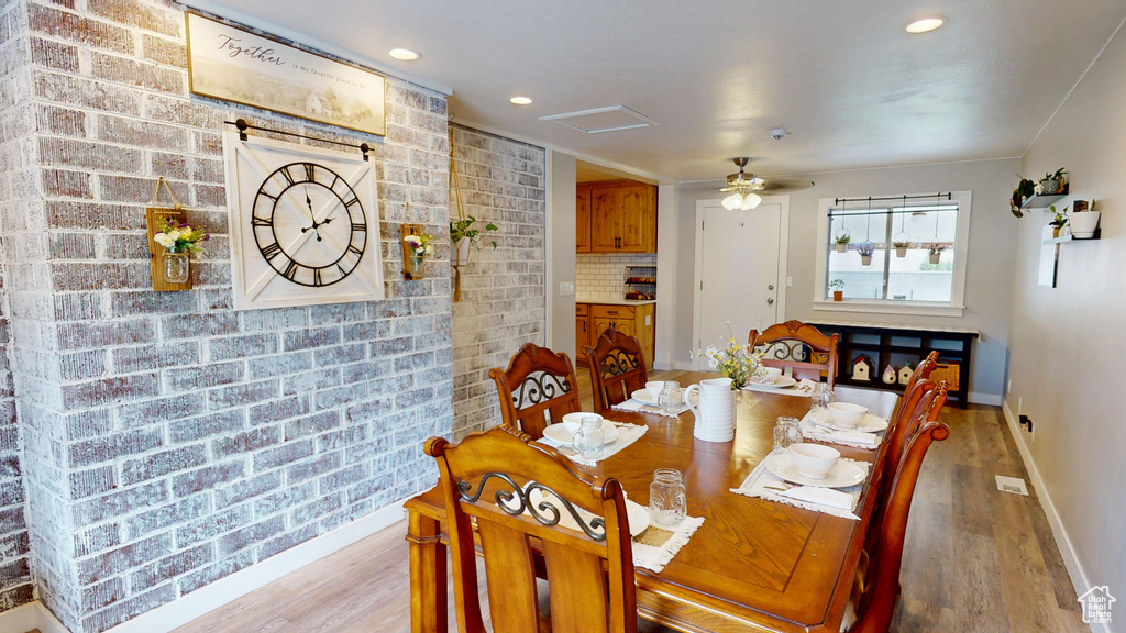 Dining area featuring light wood-style flooring and baseboards