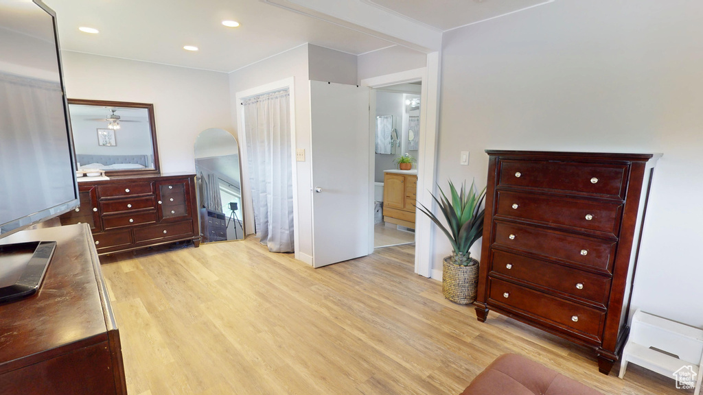 Bedroom with light wood-type flooring, recessed lighting, and arched walkways