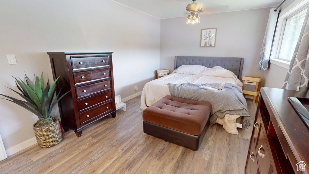Bedroom with light wood finished floors and baseboards