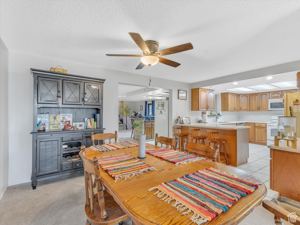 Dining room featuring ceiling fan, a textured ceiling, and recessed lighting