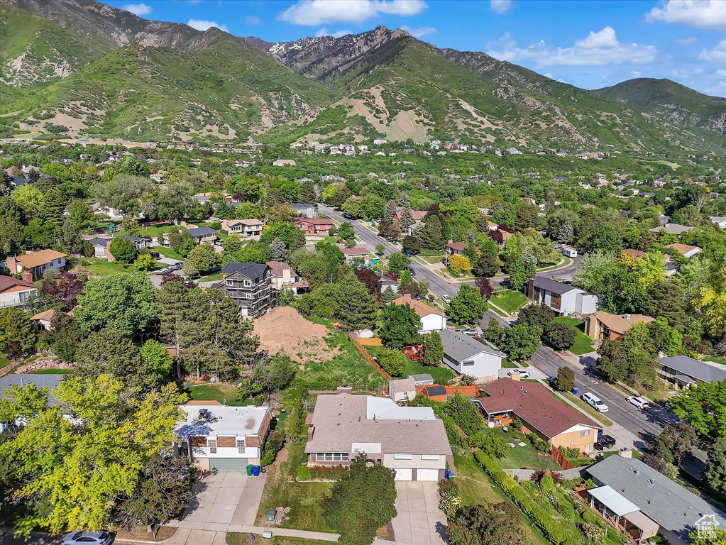 Aerial view of property's location featuring a mountain backdrop and nearby suburban area