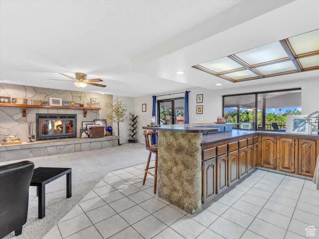 Kitchen with plenty of natural light, a kitchen bar, open floor plan, ceiling fan, and recessed lighting