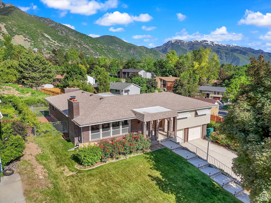 Aerial view of property and surrounding area featuring mountains