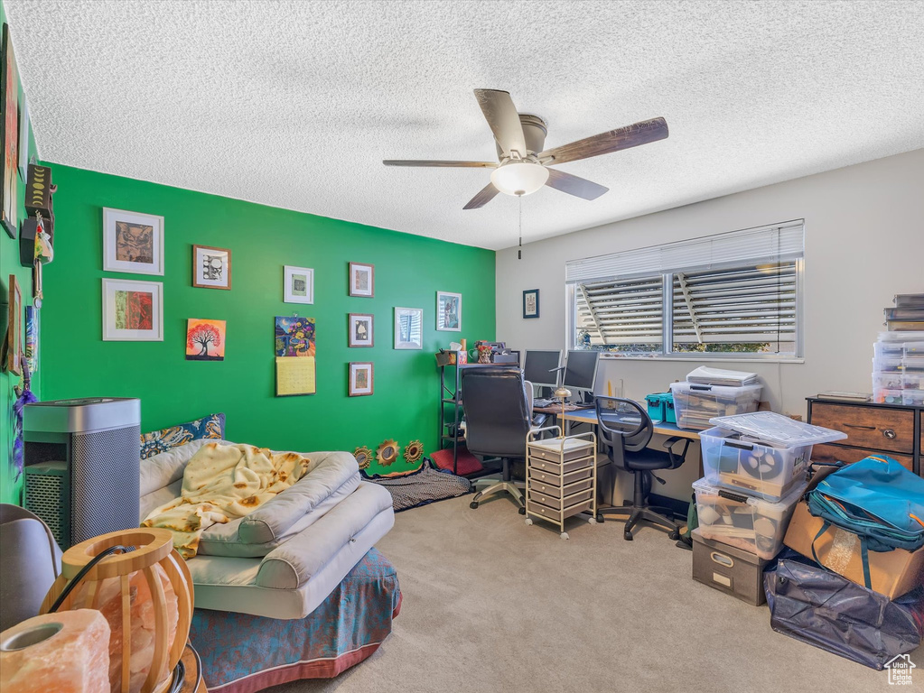 Office with ceiling fan, carpet, and a textured ceiling