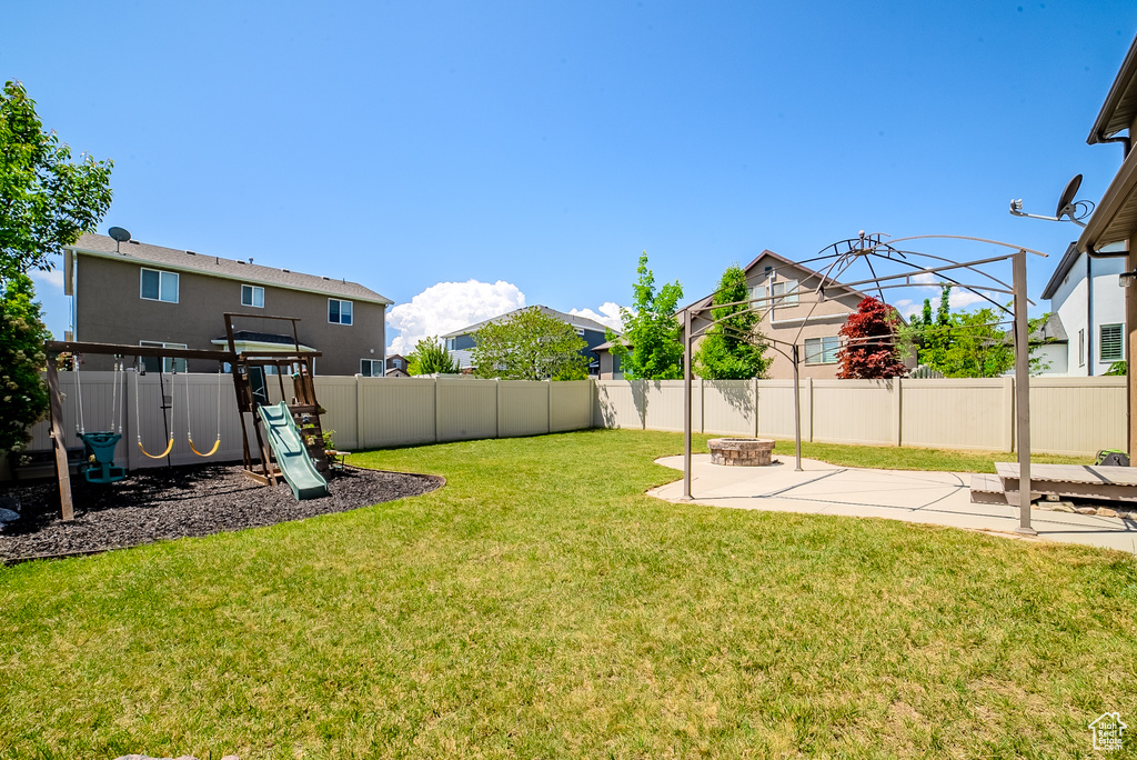 View of yard featuring a patio area and a playground