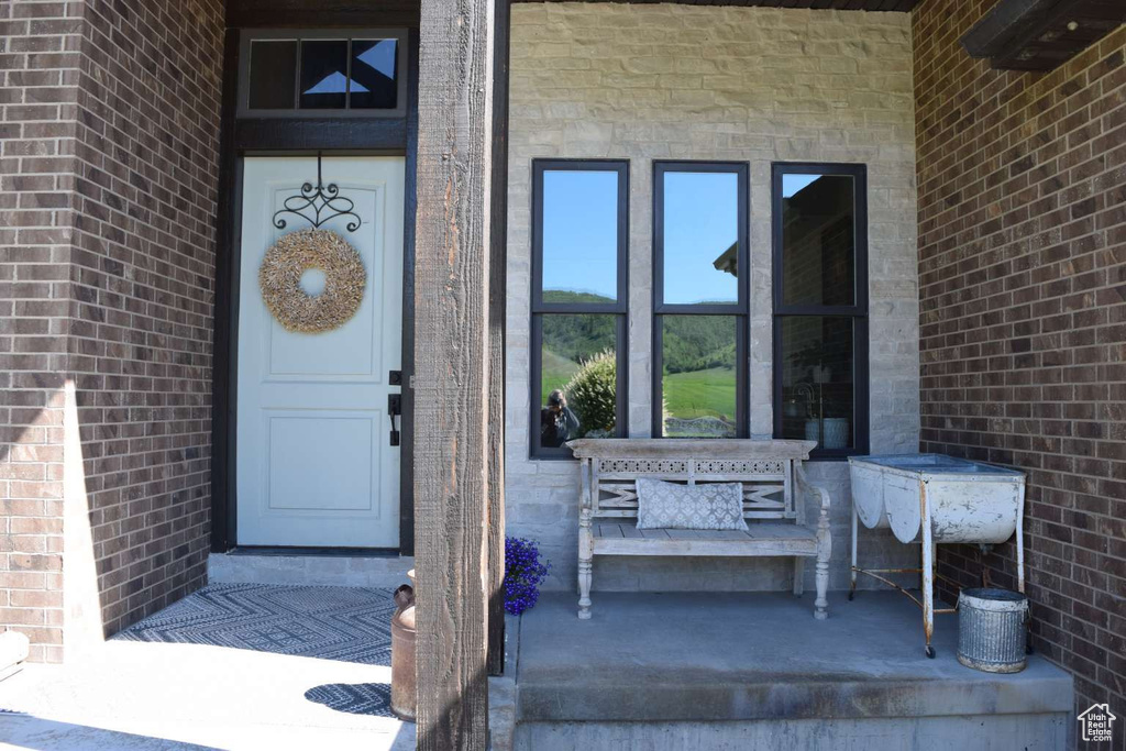 Doorway to property with stone siding