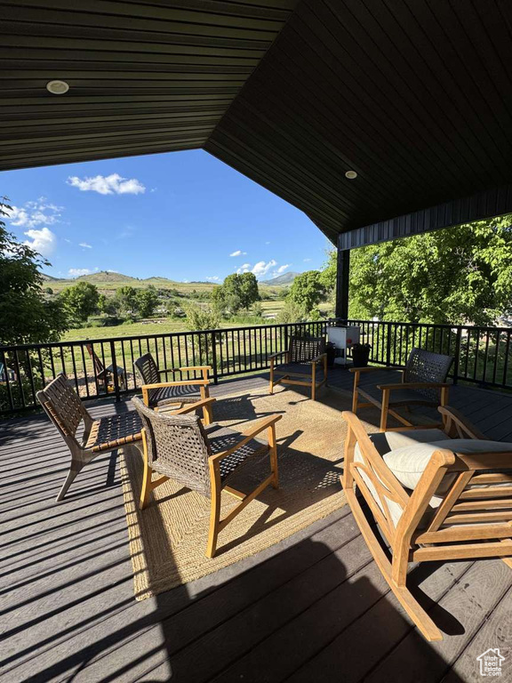Wooden terrace featuring a mountain view
