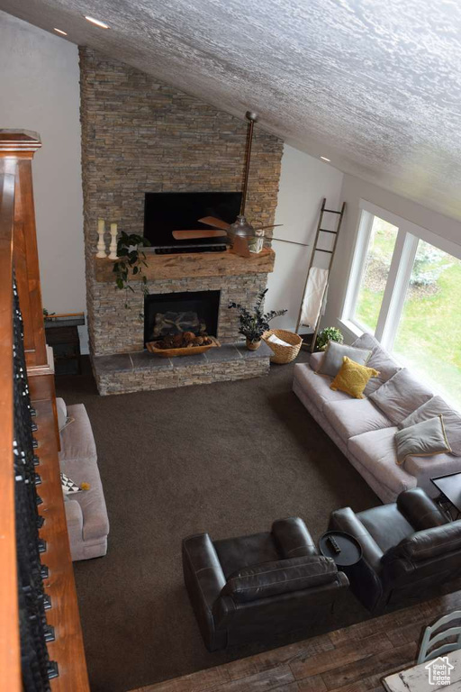 Living room with a fireplace and lofted ceiling