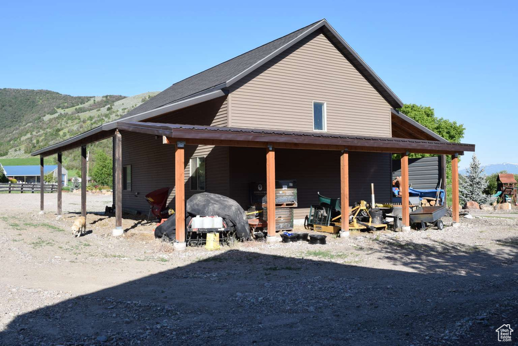 View of side of property with a mountain view