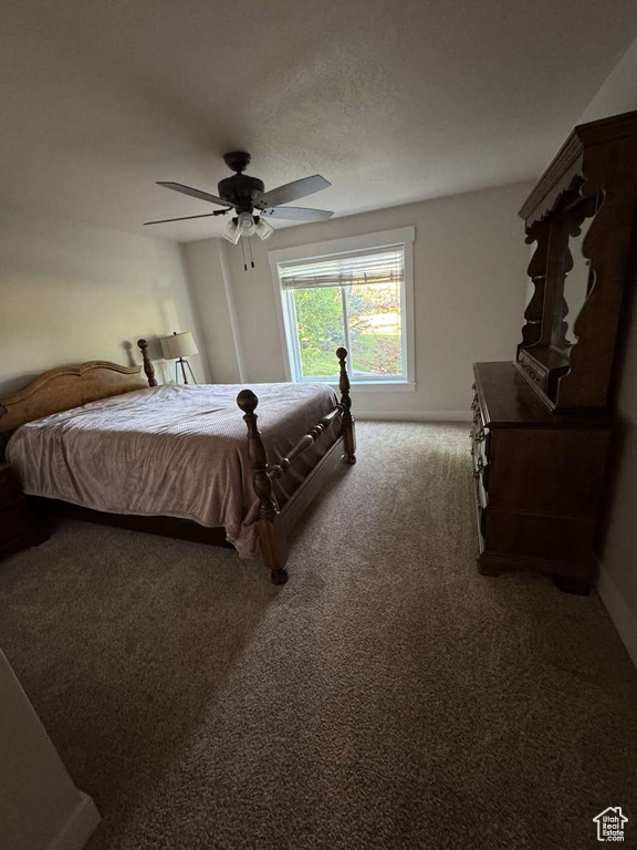 Bedroom with carpet flooring, baseboards, and ceiling fan