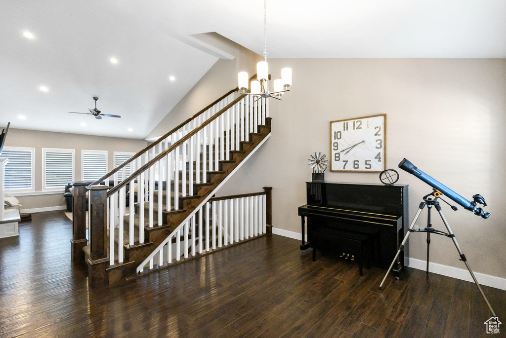 Stairway featuring baseboards, wood finished floors, a ceiling fan, recessed lighting, and a chandelier
