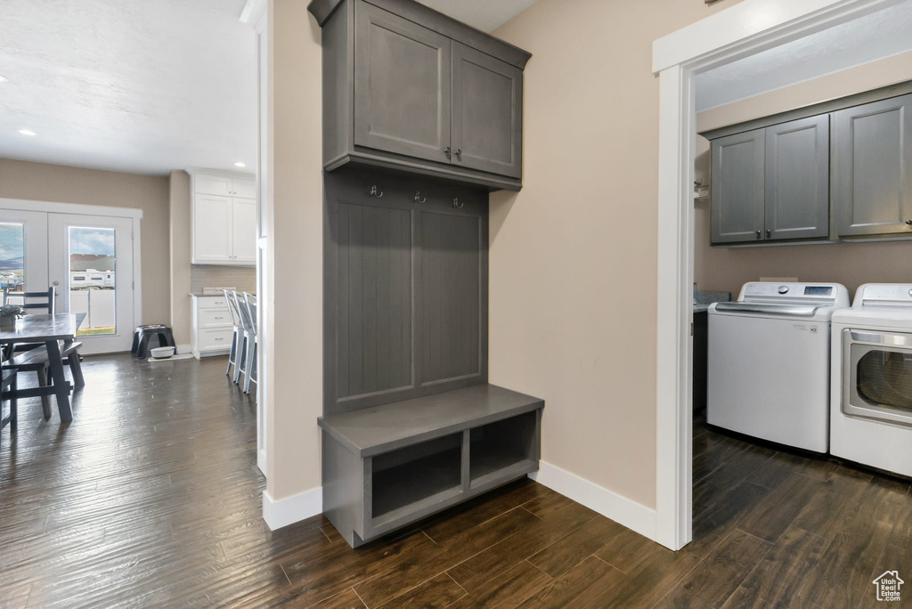 Washroom with separate washer and dryer, cabinet space, baseboards, dark wood-style flooring, and recessed lighting