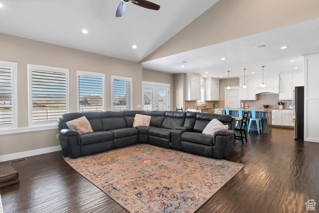 Living area featuring a ceiling fan, dark wood-style floors, baseboards, recessed lighting, and high vaulted ceiling