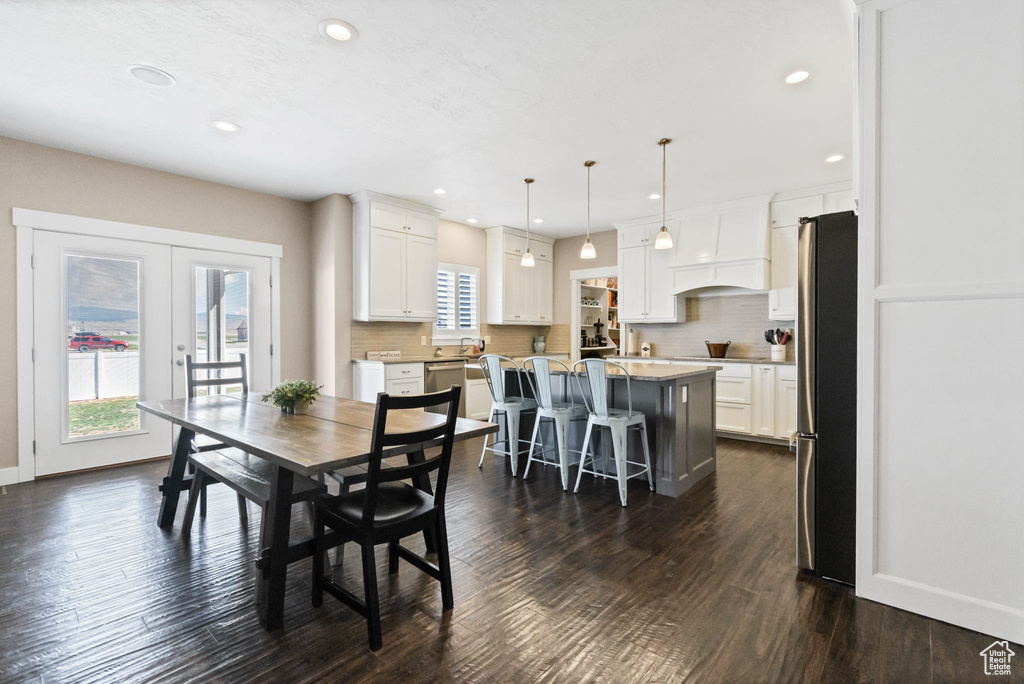 Dining room featuring french doors, dark wood finished floors, recessed lighting, and baseboards