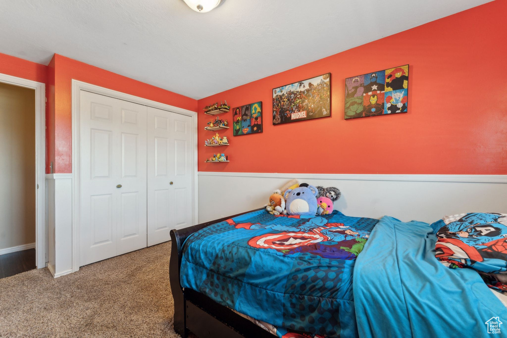 Carpeted bedroom with a closet