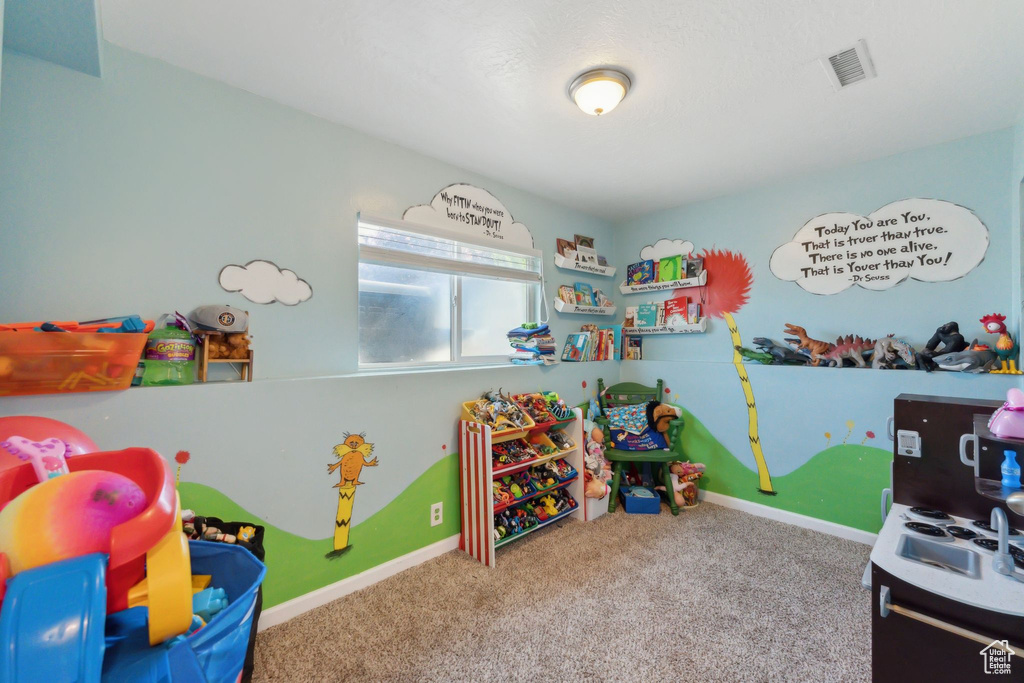 Game room with carpet floors and baseboards