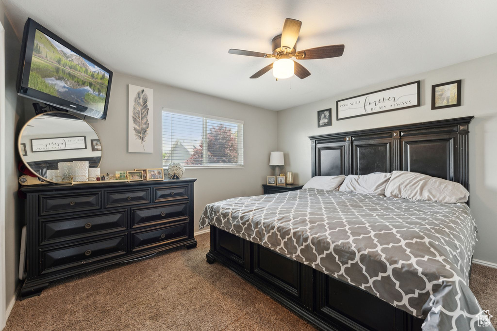 Bedroom with carpet, baseboards, and a ceiling fan