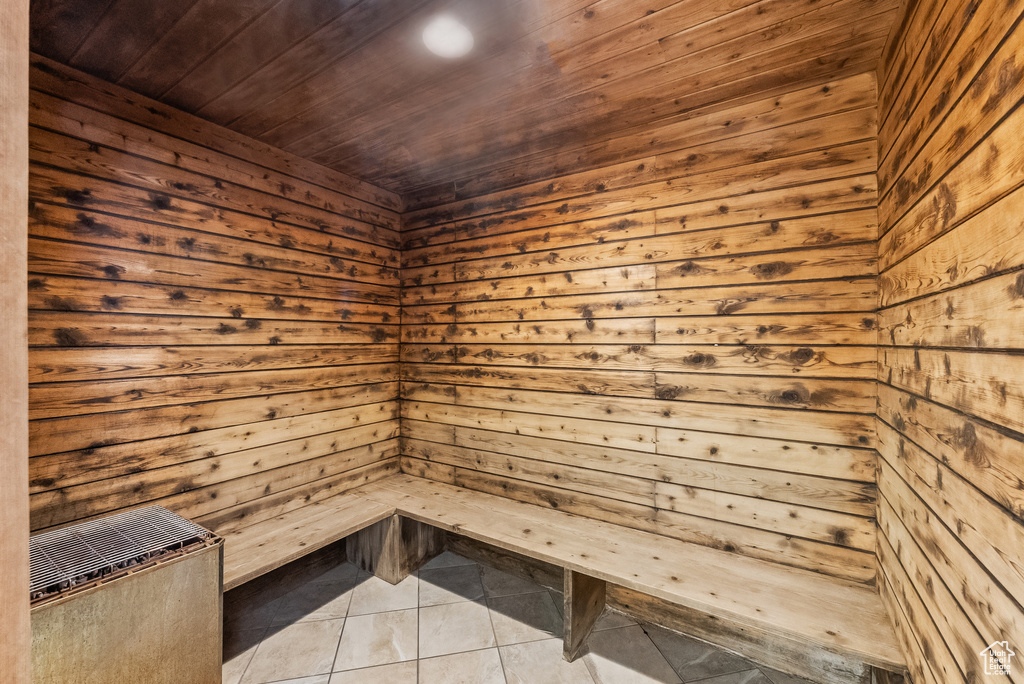 Sauna / steam room featuring tile patterned flooring, wood walls, and wood ceiling