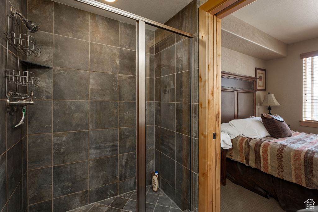 Ensuite bathroom featuring a stall shower