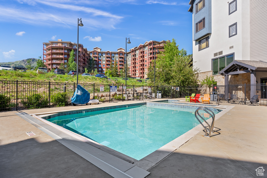Community pool featuring a patio