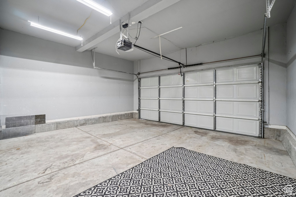 Garage featuring a garage door opener