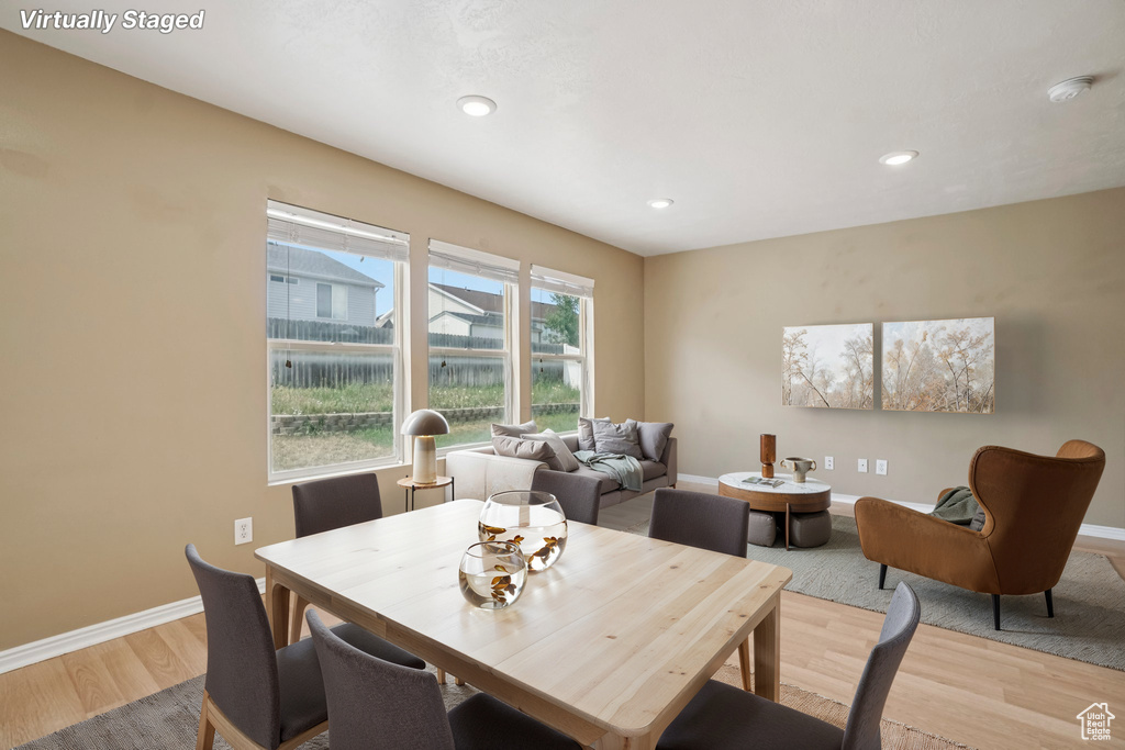 Dining space with light wood-type flooring, baseboards, and recessed lighting