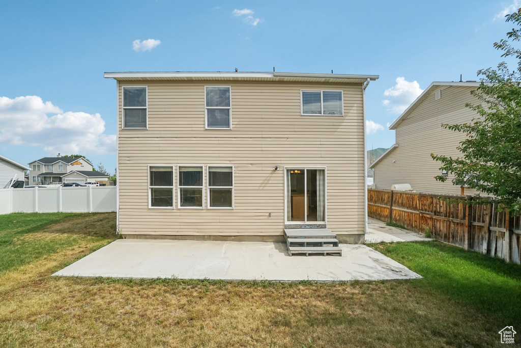 Rear view of property with a patio
