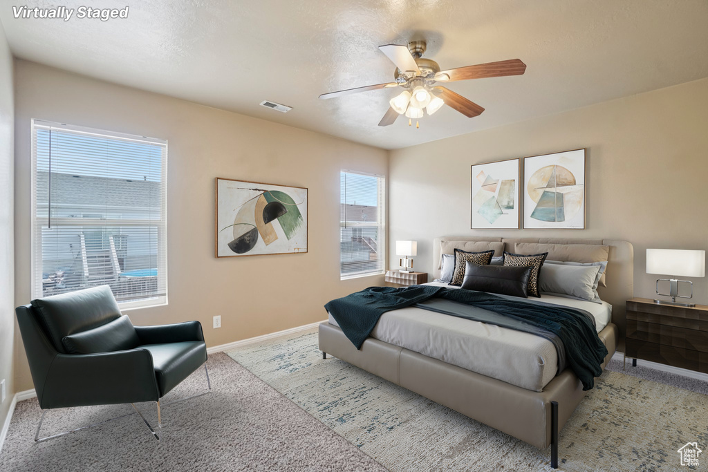 Bedroom with carpet, baseboards, and ceiling fan