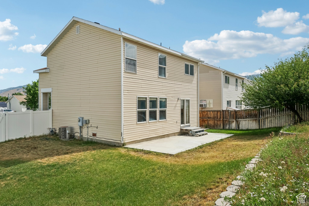 Back of house featuring a patio and central AC unit