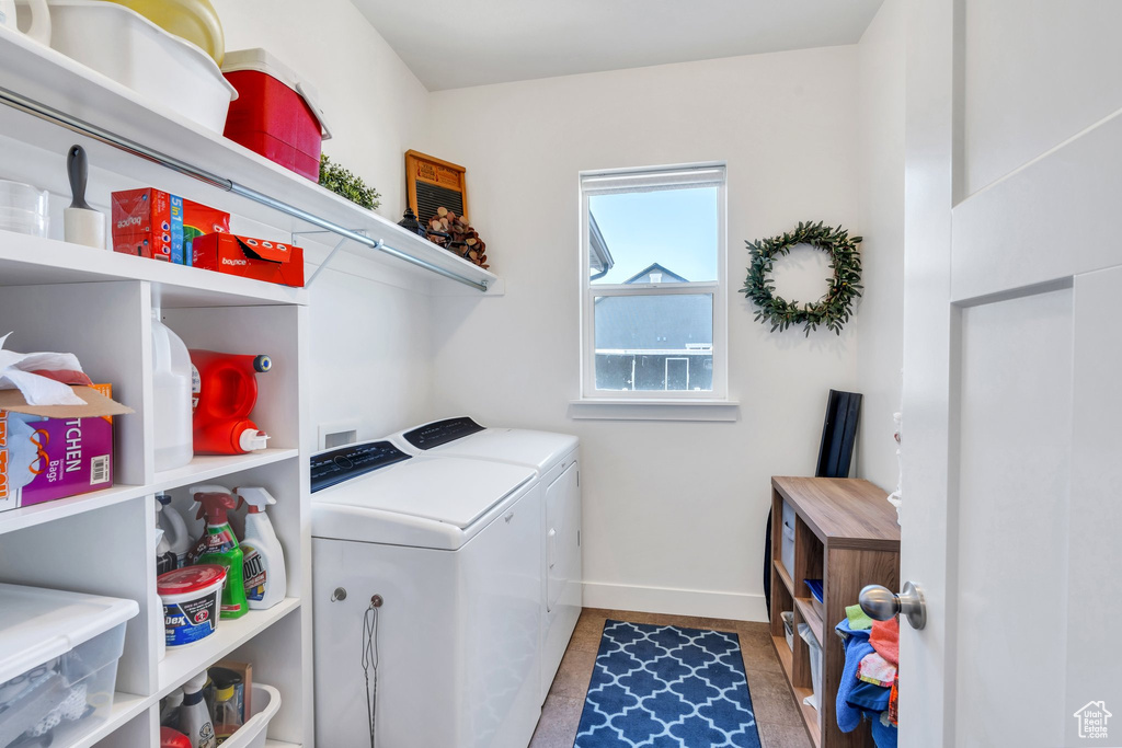 Laundry room featuring washing machine and clothes dryer and baseboards