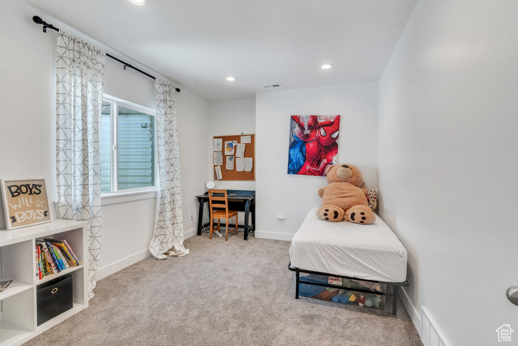 Carpeted bedroom with baseboards and recessed lighting