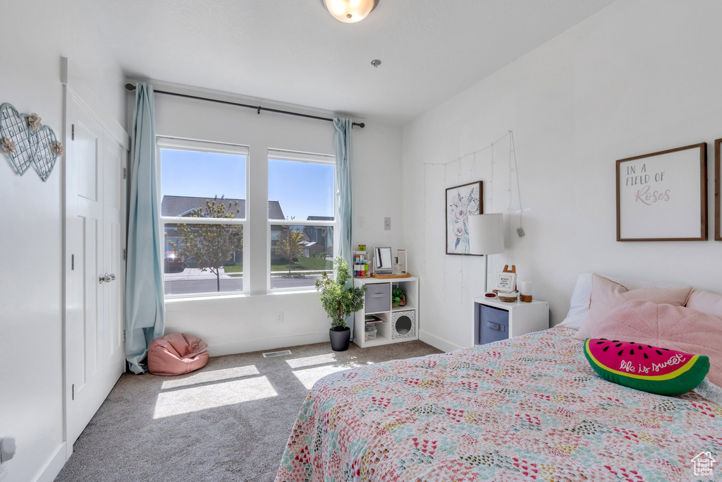 Bedroom with carpet floors and baseboards