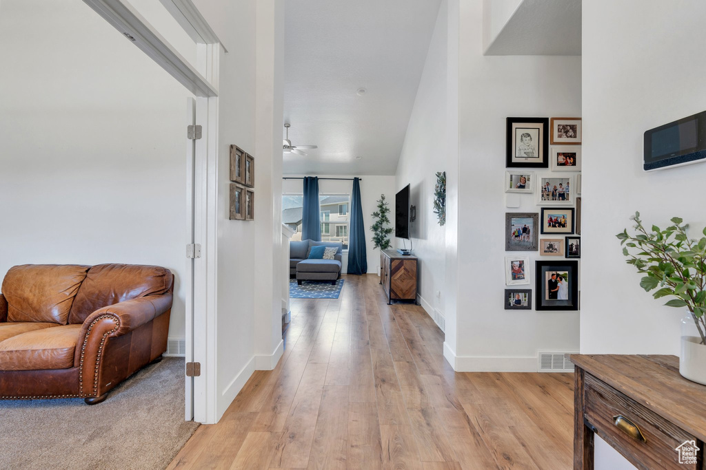 Hallway featuring light wood-style floors and baseboards