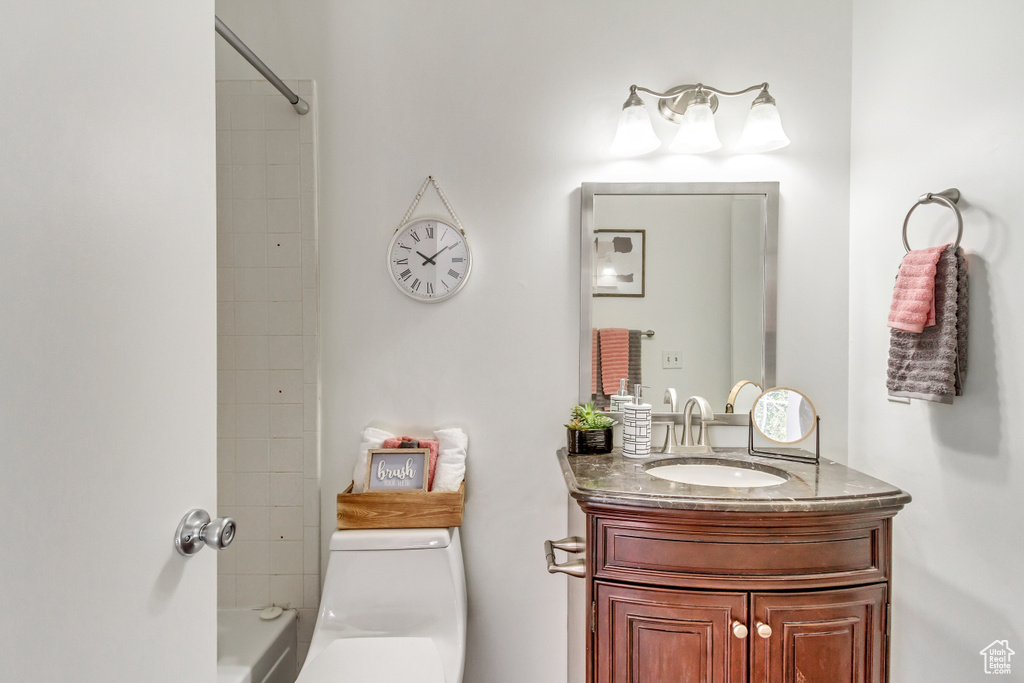 Bathroom featuring vanity, toilet, and shower / bathtub combination