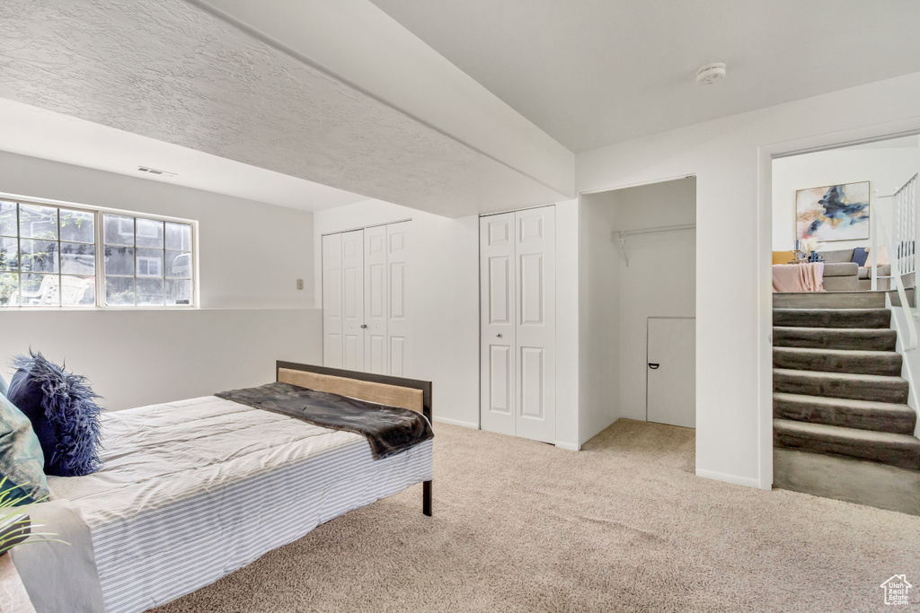 Carpeted bedroom featuring two closets