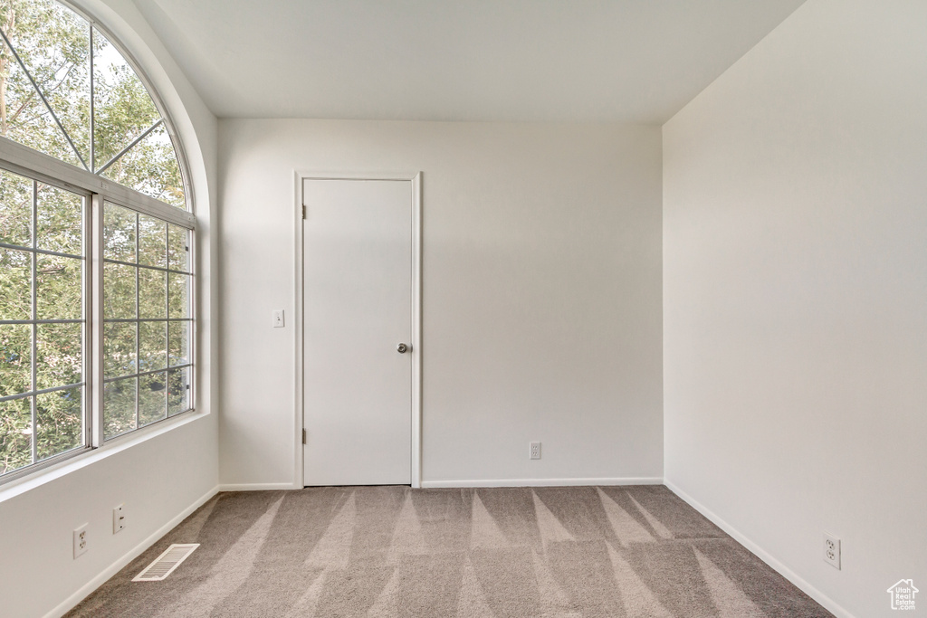 Unfurnished room with baseboards and carpet