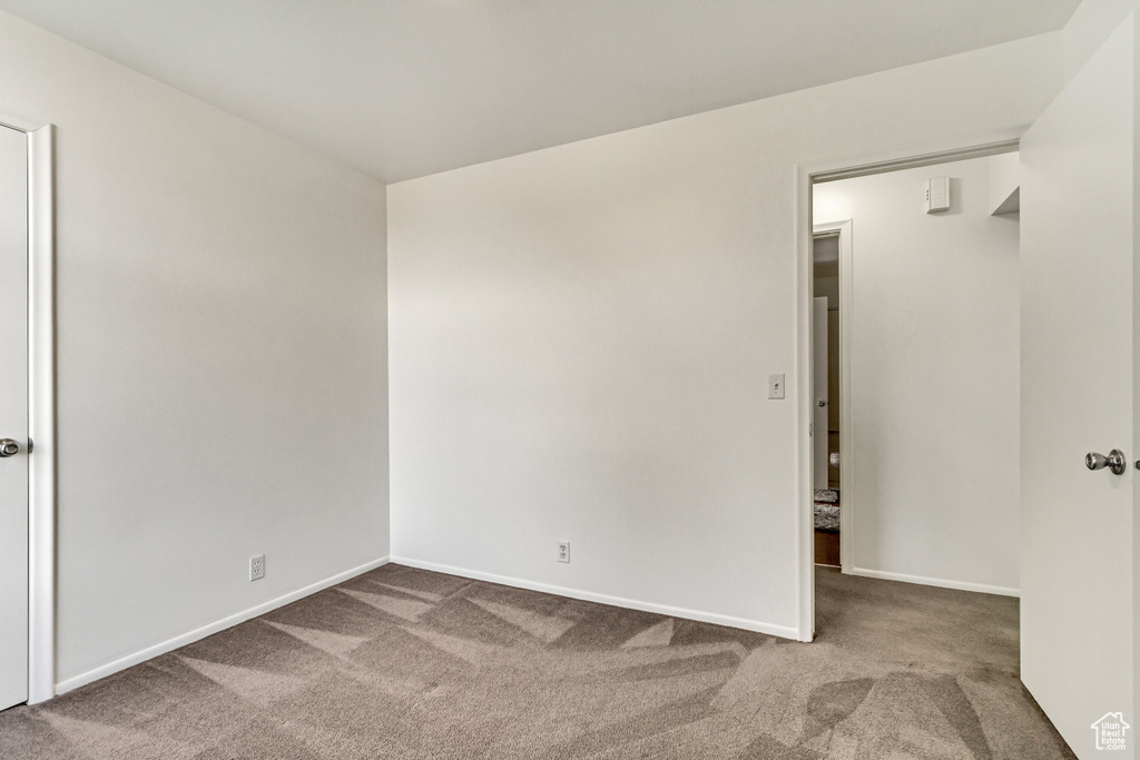 Carpeted spare room with baseboards