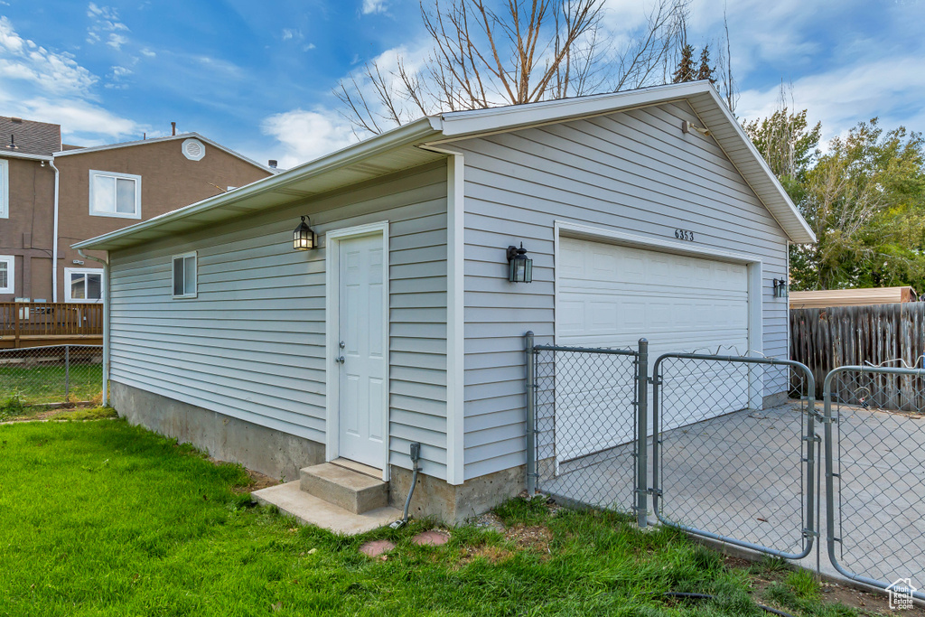 Detached garage featuring a gate